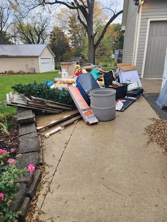 Dumpster being loaded with debris for Estate Cleanout Dumpster Rental in Folsom